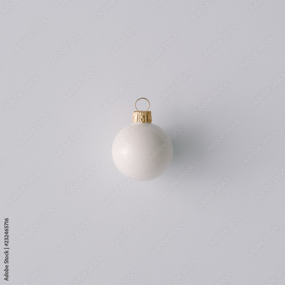 White Christmas ball Ornament on pastel gray background. minimal concept idea. Flat lay, top view. Christmas sale card concept. White Christmas ball Ornament on pastel gray background. minimal concept idea. Flat lay, top view. Christmas sale card concept.