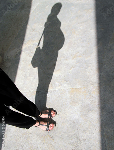 Shadow of a young pregnant woman
