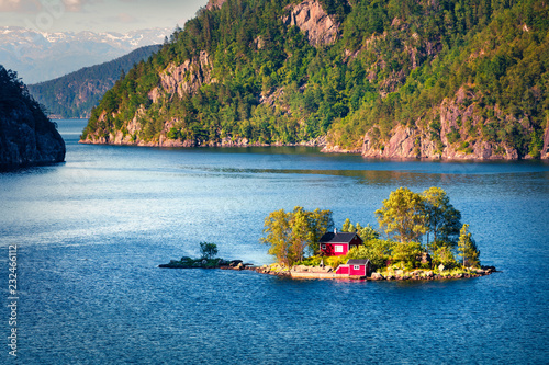 Picturesque summer view with small island with typical Norwegian building on Lovrafjorden flord, North sea. Colorful morning view in Norway. Beauty of nature concept background. photo