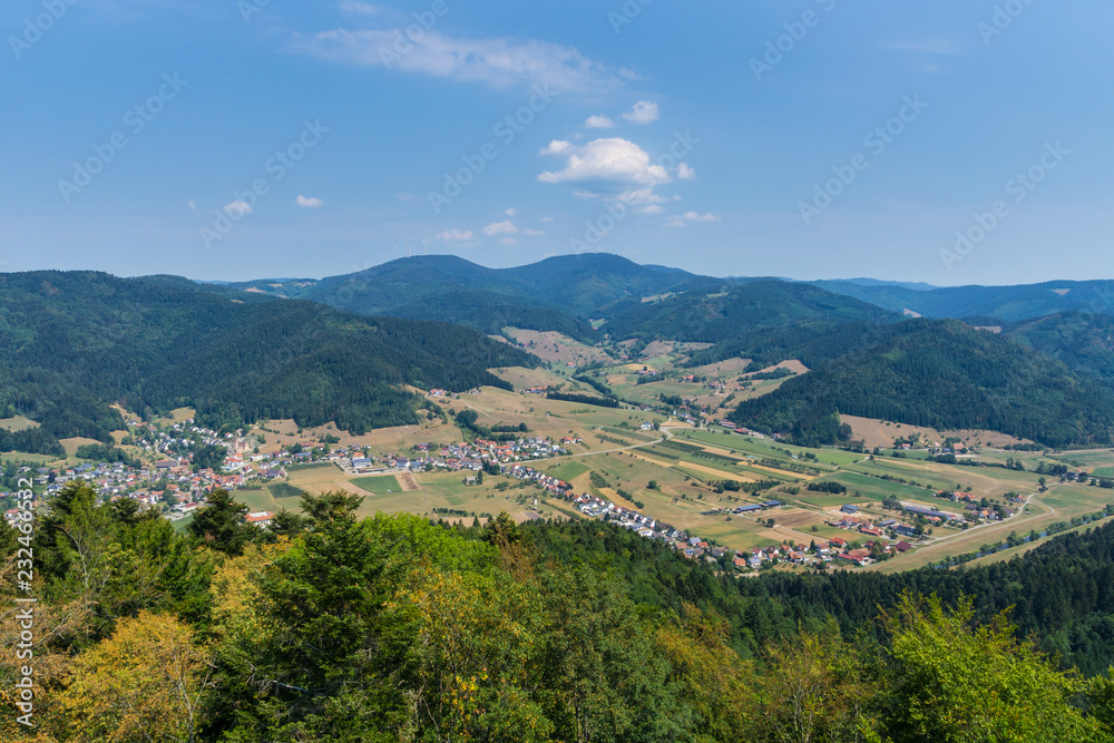 Germany, Aerial view on black forest villages between tree covered mountains