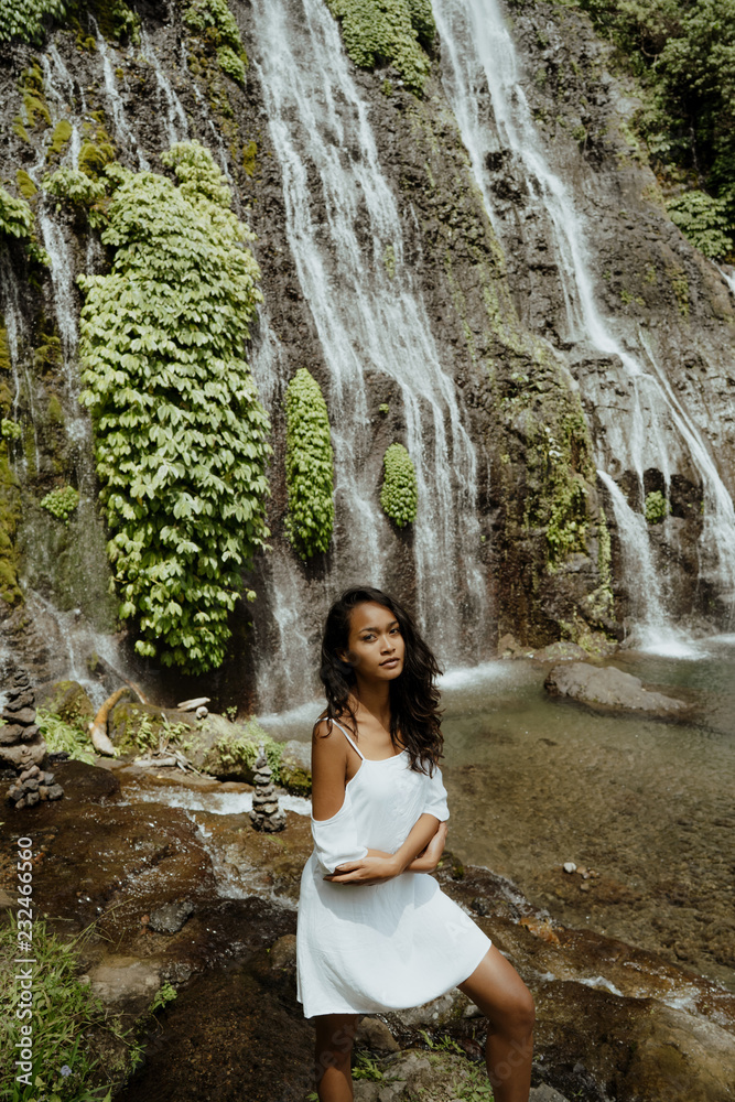 Female tourist enjoying waterfall Female tourist enjoying waterfall