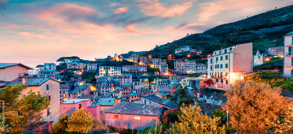 First city of the Cique Terre sequence of hill cities - Riomaggiore. Colorful spring sunset in  Liguria, Italy, Europe. Great evening seascape of Mediterranean sea. Traveling concept background.