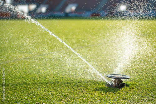 Watering grass at the football stadium