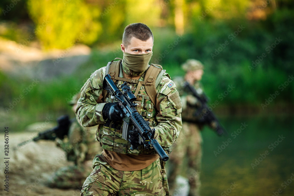 Special forces soldiers with weapon take part in military maneuver. war, army, technology and people concept.