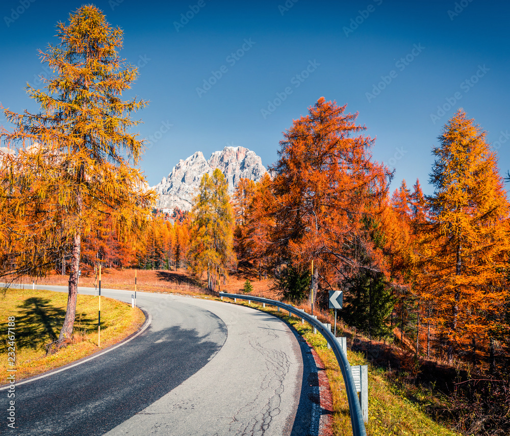 Fantastic sunny view of Dolomite Alps with yellow larch trees. Colorful autumn scene of mountains. Giau pass location, Italy, Europe. Artistic style post processed photo. Fantastic sunny view of Dolomite Alps with yellow larch trees. Colorful autumn scene of mountains. Giau pass location, Italy, Europe. Artistic style post processed photo.