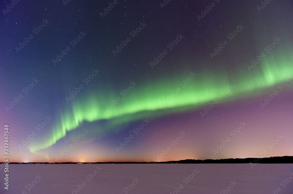 Aurora Borealis, Northern Lights, above frozen lake after sunset