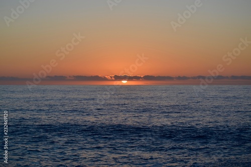 Sunset on the Indian Ocean - sun and clouds on the water