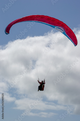 guy in a paragliding on the beach