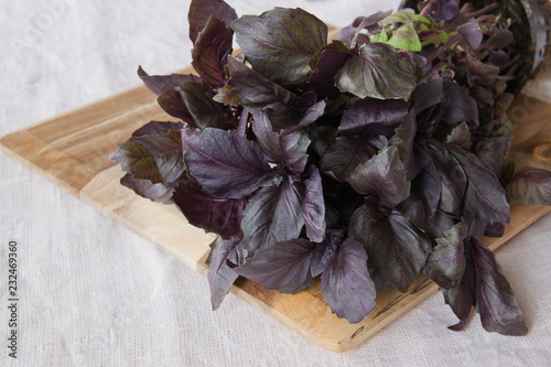 Fresh red basil on white table, close up view.