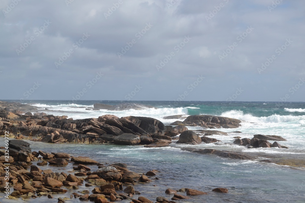 ocean waves crashing on rocks with a cloudy sky ocean waves crashing on rocks with a cloudy sky