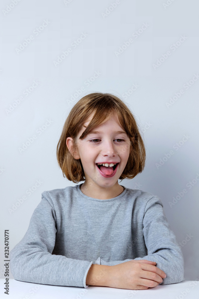 Portrait of grimacing girl sticking tongue out Portrait of grimacing girl sticking tongue out