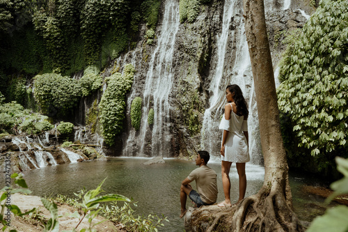 couple looking at banyumala waterfall bali