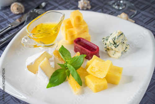 a plate with different kinds of cheese
