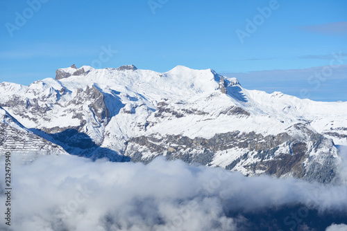 Winter mountain snowy peaks over the clouds in the valley. Jungfrau region in Switzerland. © thecolorpixels