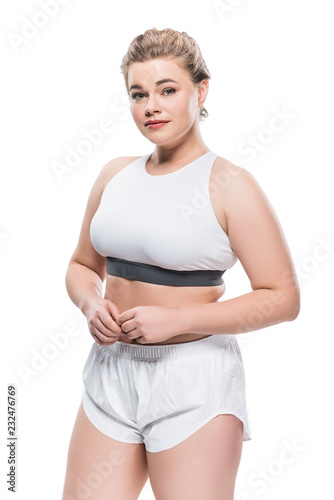 beautiful oversize girl in sportswear looking at camera isolated on white