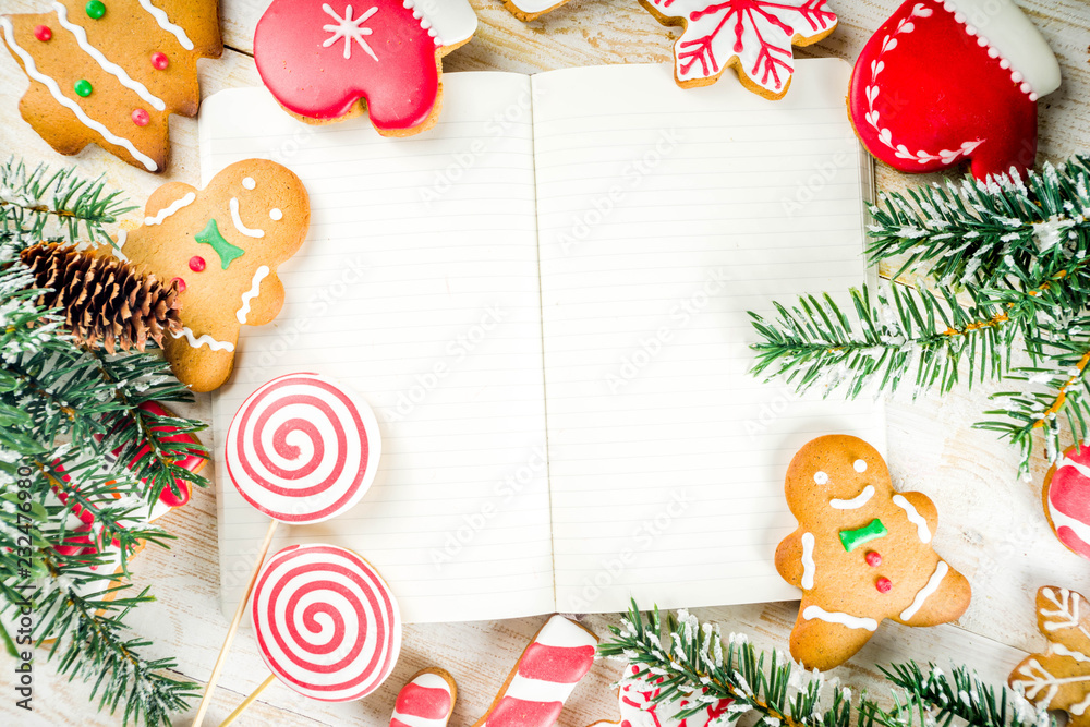 Obraz premium Christmas cookies with festive decoration on white wooden background top view copy space