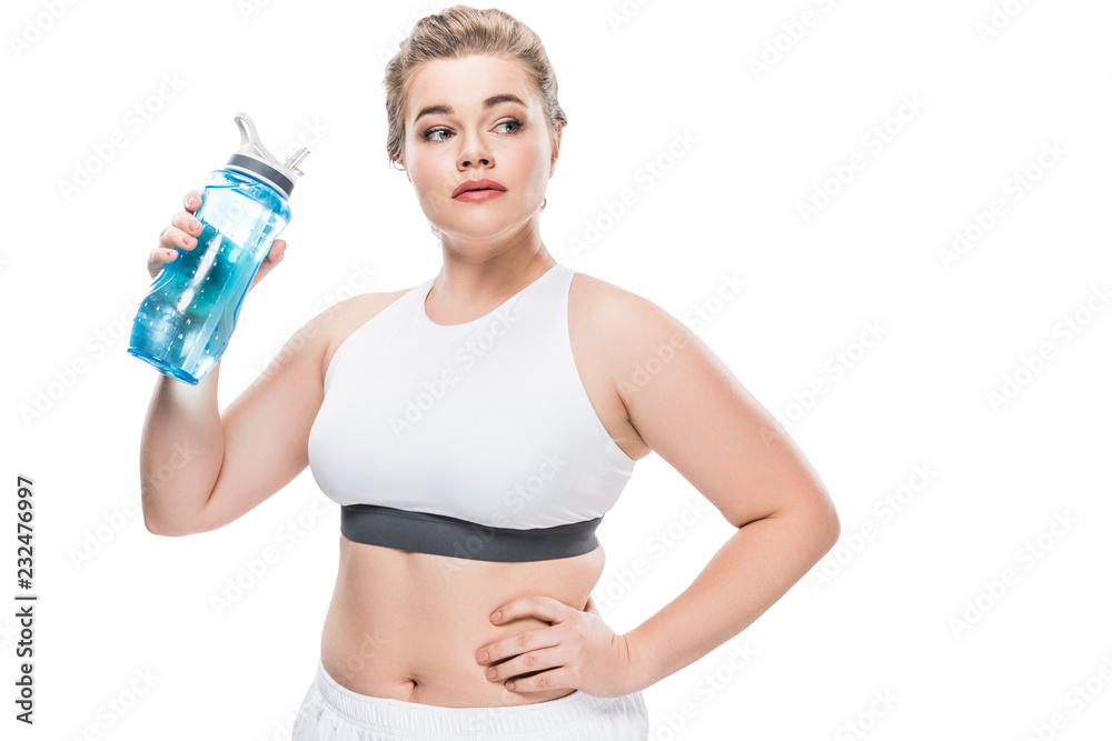 size plus woman in sportswear holding bottle of water and looking away isolated on white size plus woman in sportswear holding bottle of water and looking away isolated on white