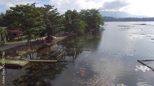 Sampaloc Lake, San Pablo City, Laguna, Philippines - November 21, 2017:  Trees and vegetation on mountain lake shore. Drone aerial. photo