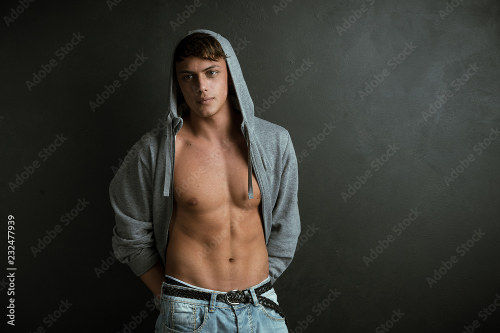 Portrait of strong healthy handsome Athletic Man Fitness Model isolated on black