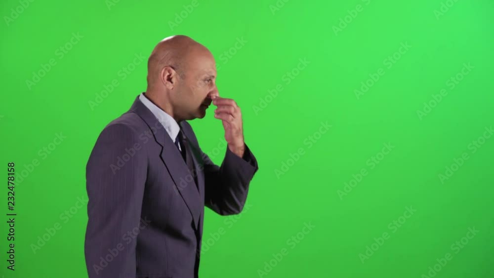 Businessman walking and claps hands, wearing a suit. medium sideways shot over a green screen. Businessman walking and claps hands, wearing a suit. medium sideways shot over a green screen.