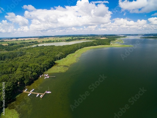 Aerial view of beautiful landscape of lake district - marina on Mamry Lake, Pniewskie Lake on the left in the distance, Mazury, Poland