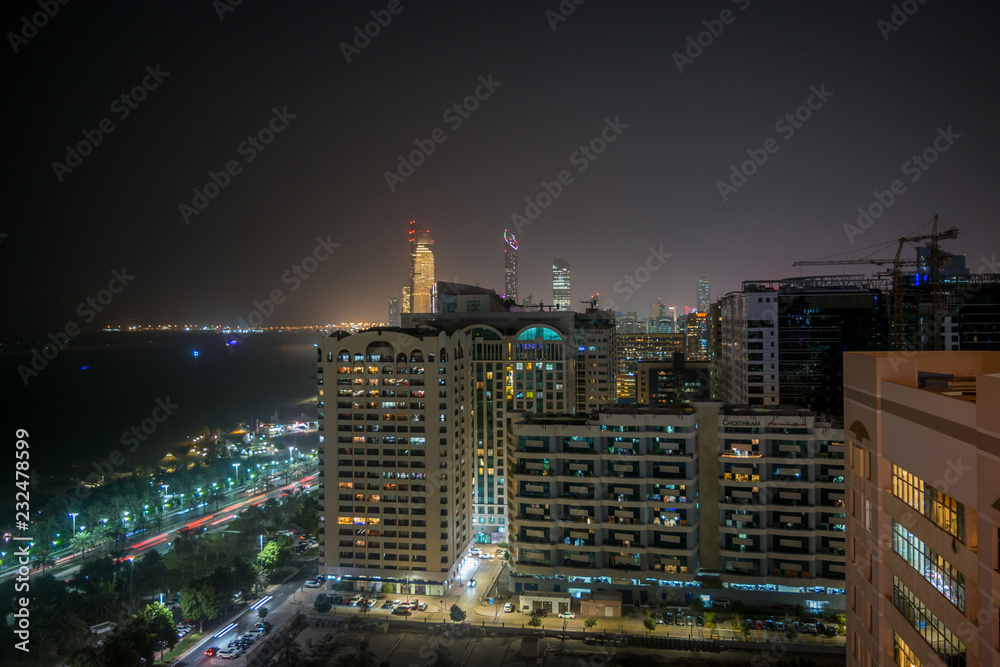 High shot of Abu Dhabi city towers and skyline at night - Corniche view High shot of Abu Dhabi city towers and skyline at night - Corniche view