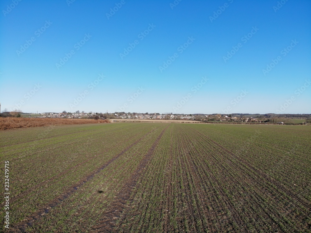 Farmers field aerial photo taken on a clear blue sky day in Leeds West Yorkshire UK
