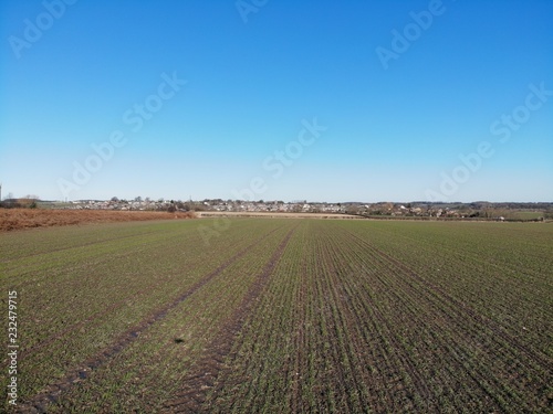 Farmers field aerial photo taken on a clear blue sky day in Leeds West Yorkshire UK