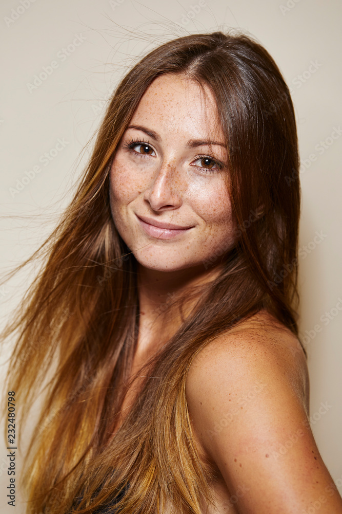 Portrait of smiling young woman with freckles