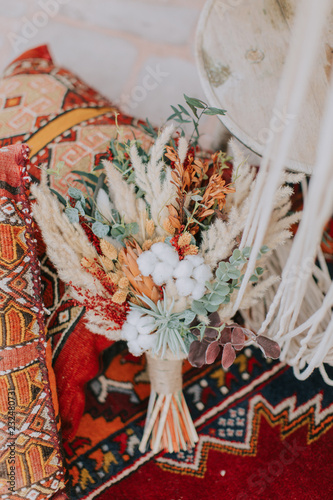 Bridal bouquet on historic hand-woven rug