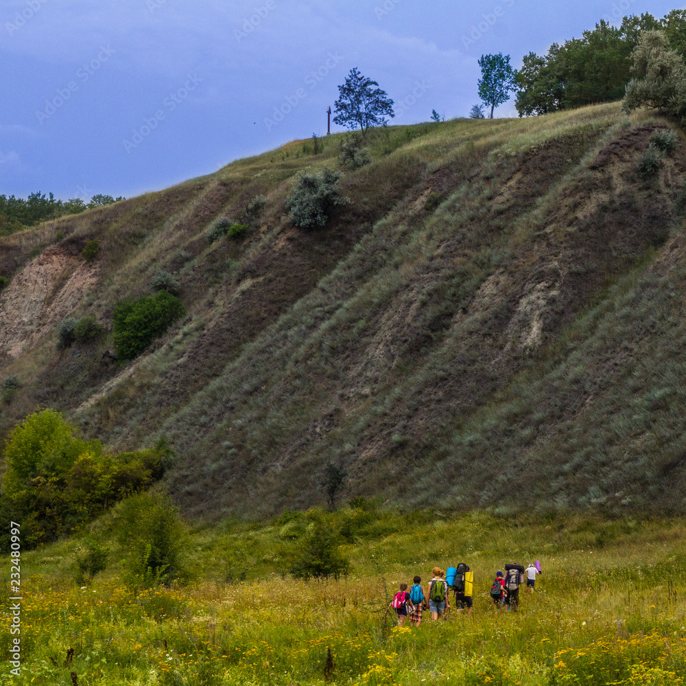 A small group of children goes on a hike.