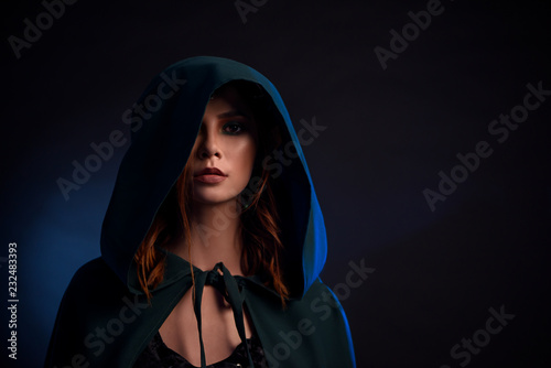 Portrait of charming girl with red hair looking at camera. 