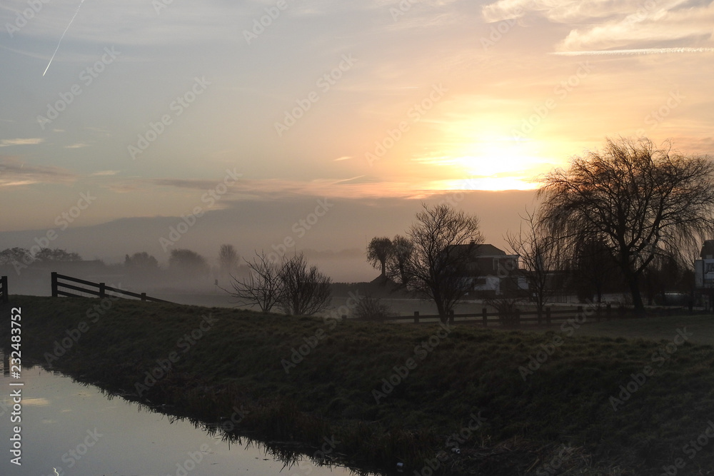 Low fog over the dutch countryside at sunrise Low fog over the dutch countryside at sunrise
