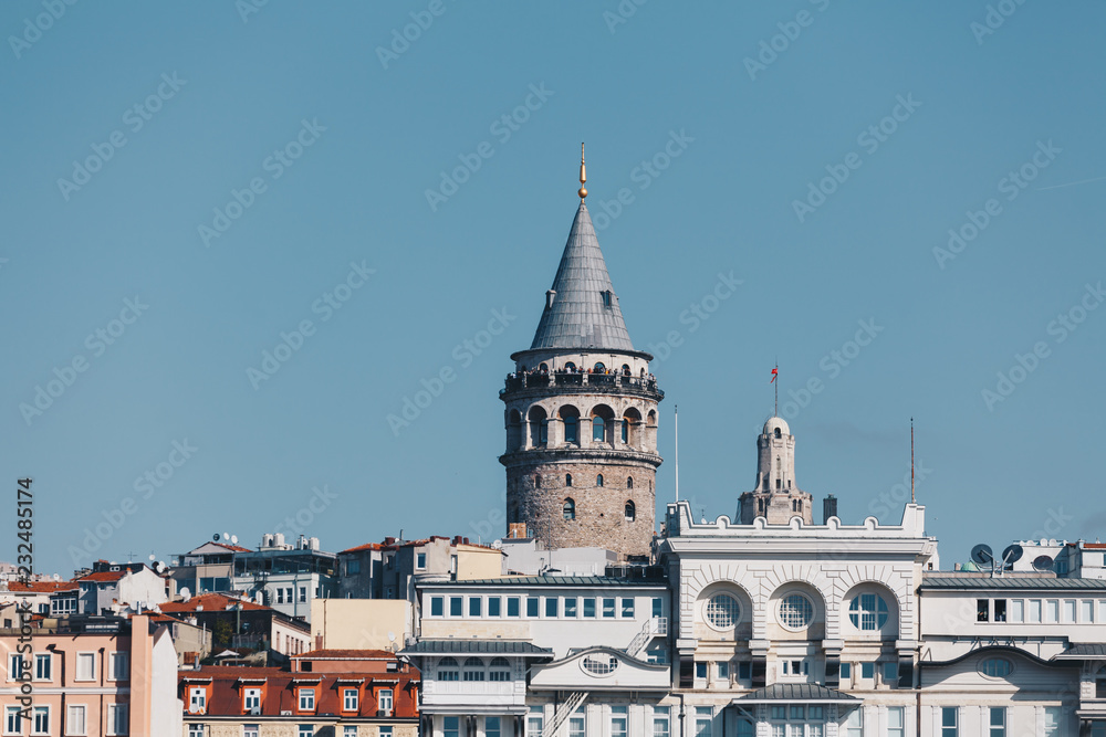 modern building and galata tower - ancient technology and religion - november 2018 - istanbul turkey