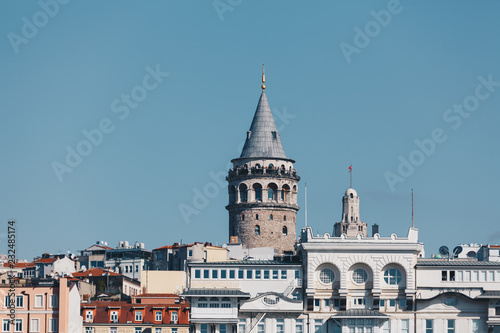 modern building and galata tower - ancient technology and religion - november 2018 - istanbul turkey