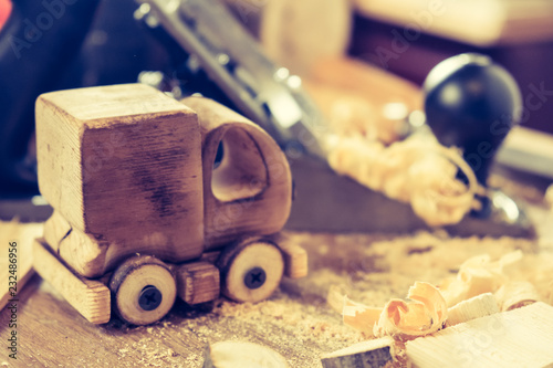 Wooden toy truck van car on the carpentry workbench. Hobby diy crafts, making