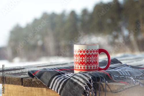 Steaming cup with hot drink outdoor photo