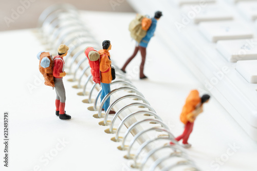 Miniature 2 people stand on The walkway the beginning of the journey To reach the goal. using as background travel concept with copy spaces for your