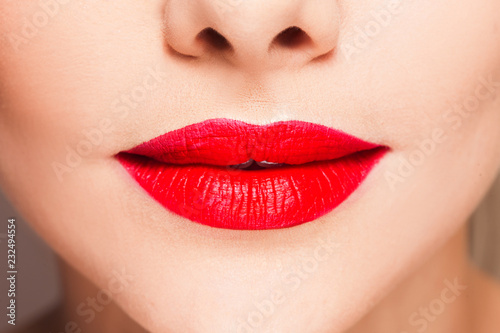 Beautiful women's lips with bright red lipstick, bright stylish makeup,