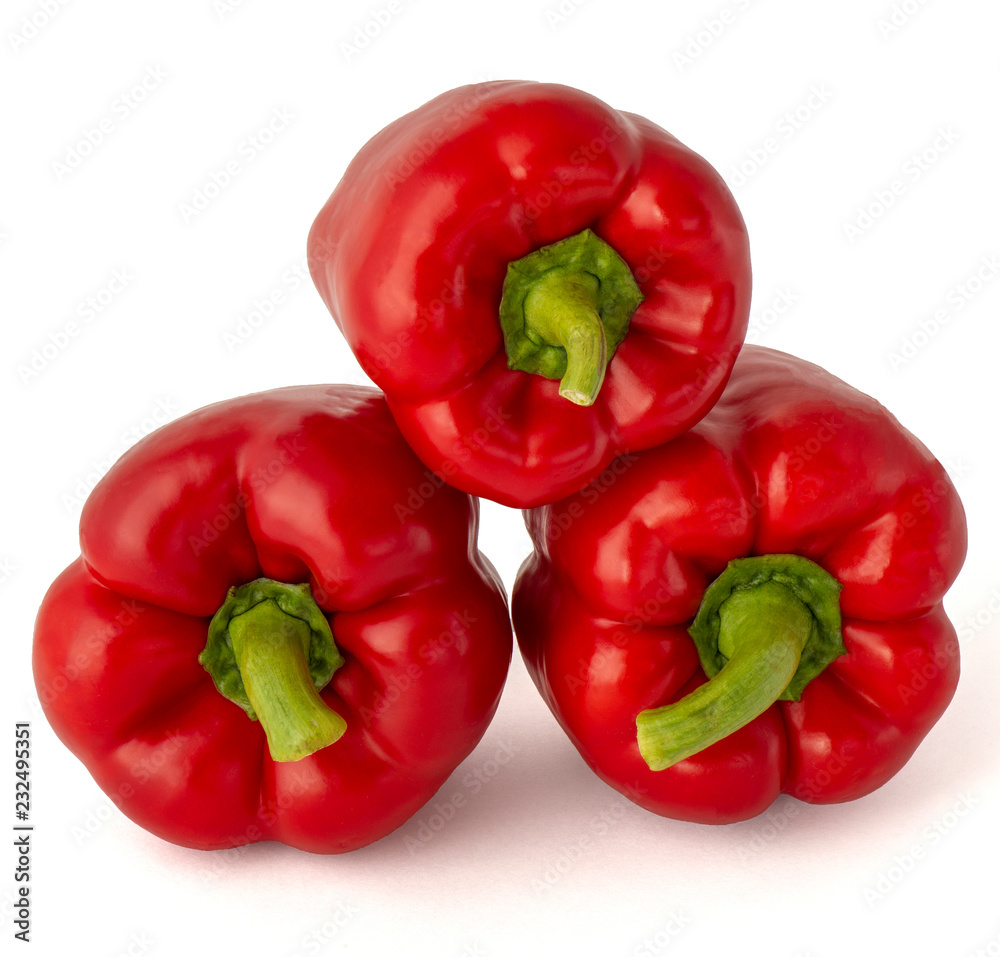 Sweet delicious yummy ripe bell peppers in red on a white background Sweet delicious yummy ripe bell peppers in red on a white background