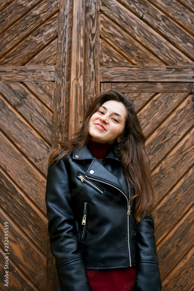 Beautiful girl in a leather jacket in the old place