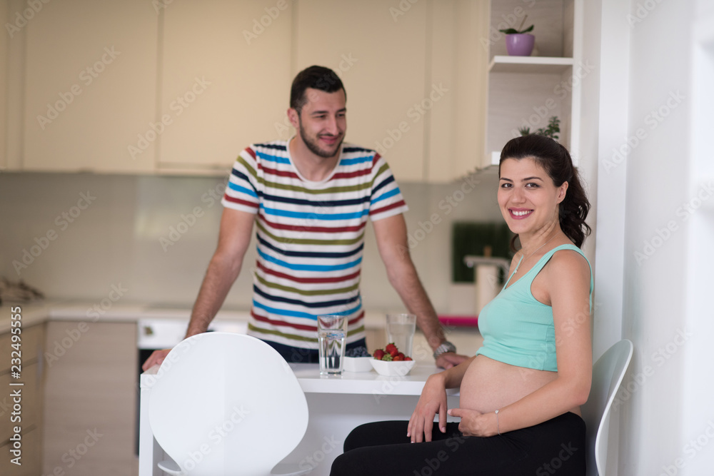 Obraz premium couple eating fruit strawberries at kitchen
