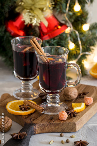 Christmas red mulled wine in glass on wood board at white background