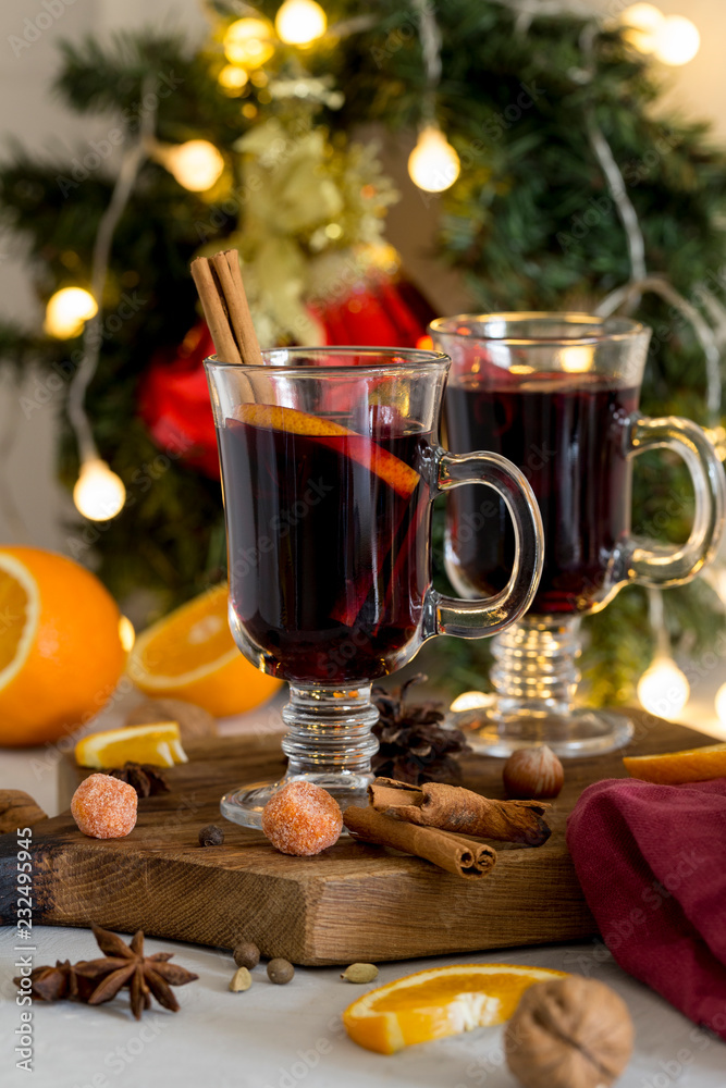 Christmas red mulled wine in glass on wood board at white background