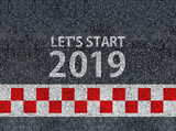 happy new year 2019. lets start 2019 and racing start line written on an asphalt road