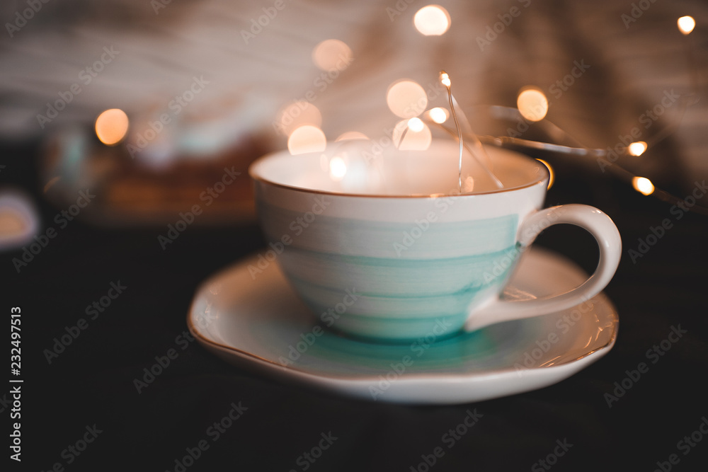 Cute cup with lights at background closeup. Christmas holidays. Cute cup with lights at background closeup. Christmas holidays.