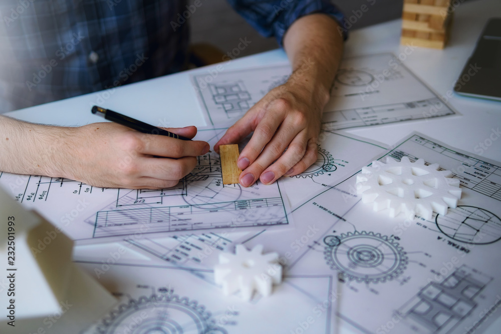 Engineering working with designing mechanical parts is using 3D printing for sample model. Engineering working with designing mechanical parts is using 3D printing for sample model.