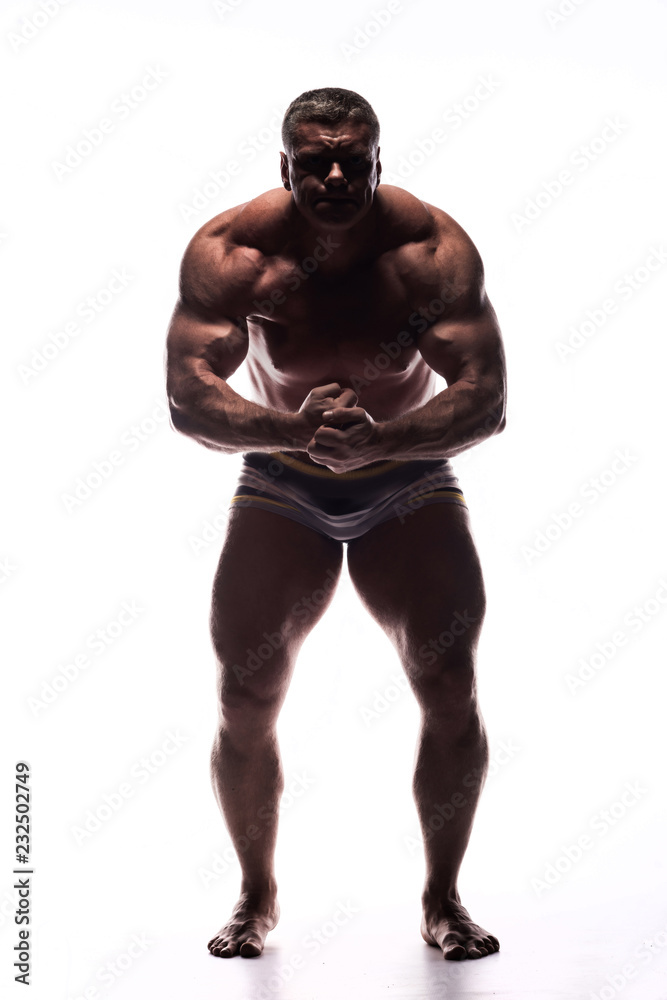 large powerful man showing his muscles in the Studio without a shirt on white background large powerful man showing his muscles in the Studio without a shirt on white background