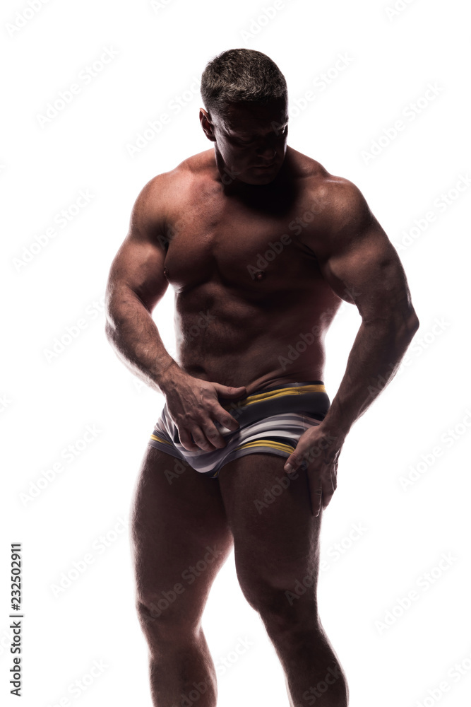 large powerful man showing his muscles in the Studio without a shirt on white background large powerful man showing his muscles in the Studio without a shirt on white background