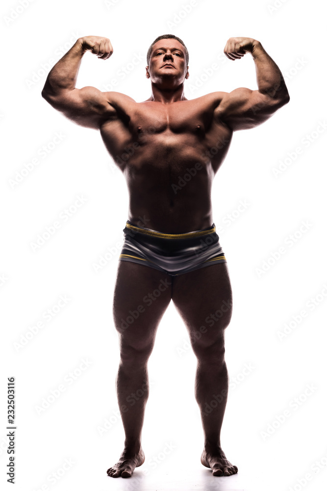 powerful man shows off his biceps in Studio shirtless on white background powerful man shows off his biceps in Studio shirtless on white background